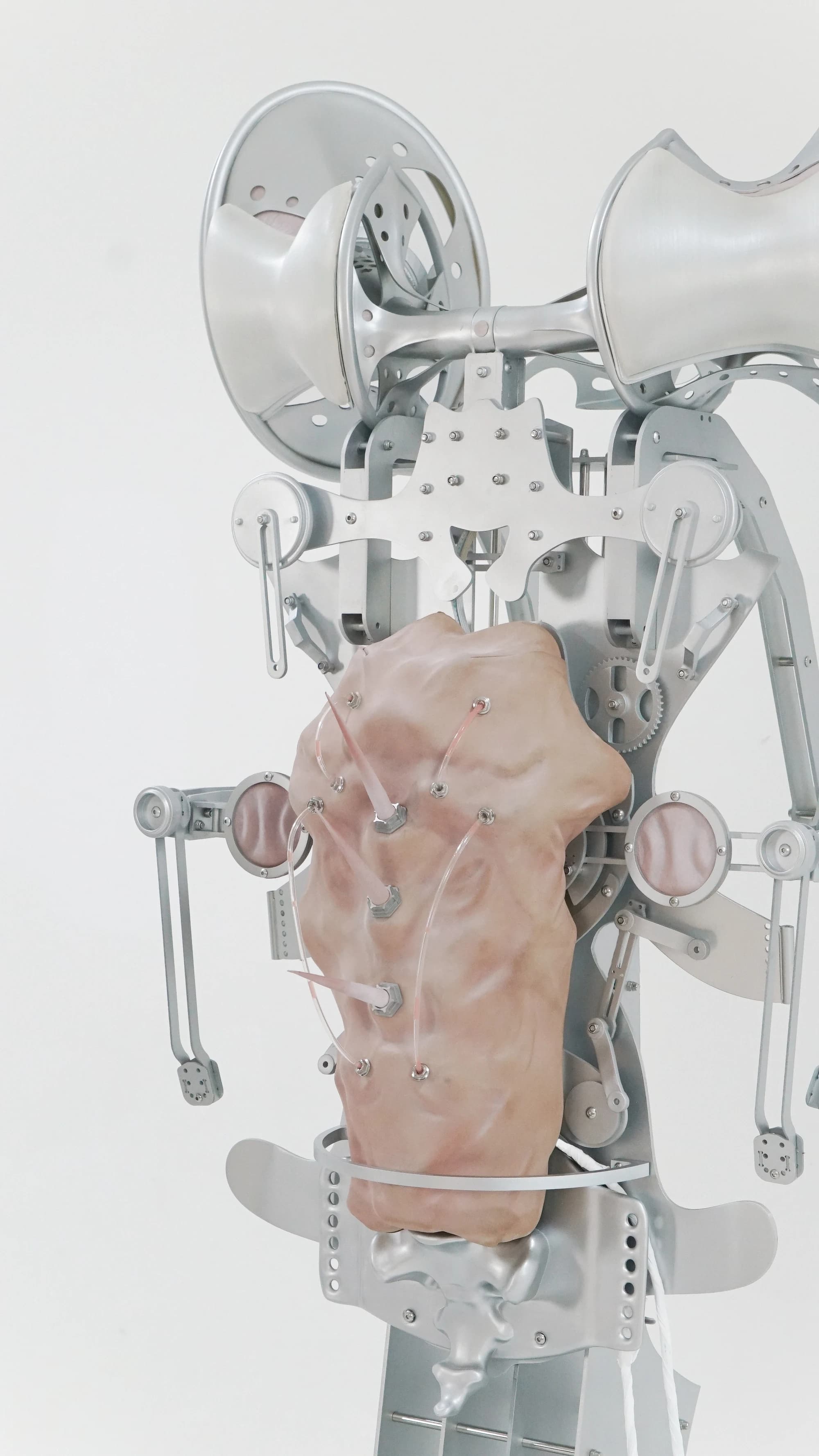 Close view of a silver wearable exoskeleton with a skin-like breathing panel