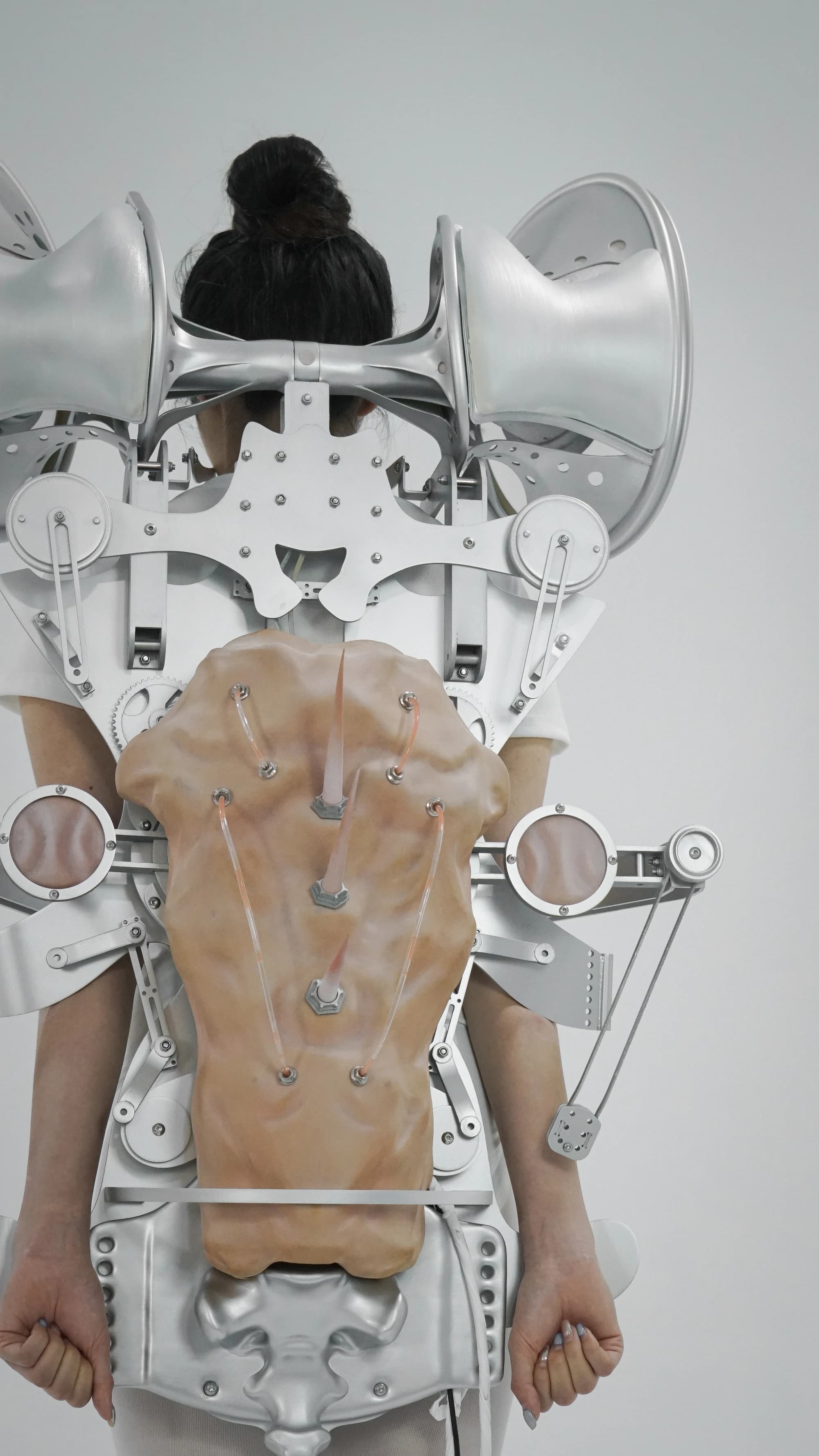 A person wearing the exoskeleton and its soft breathing panel