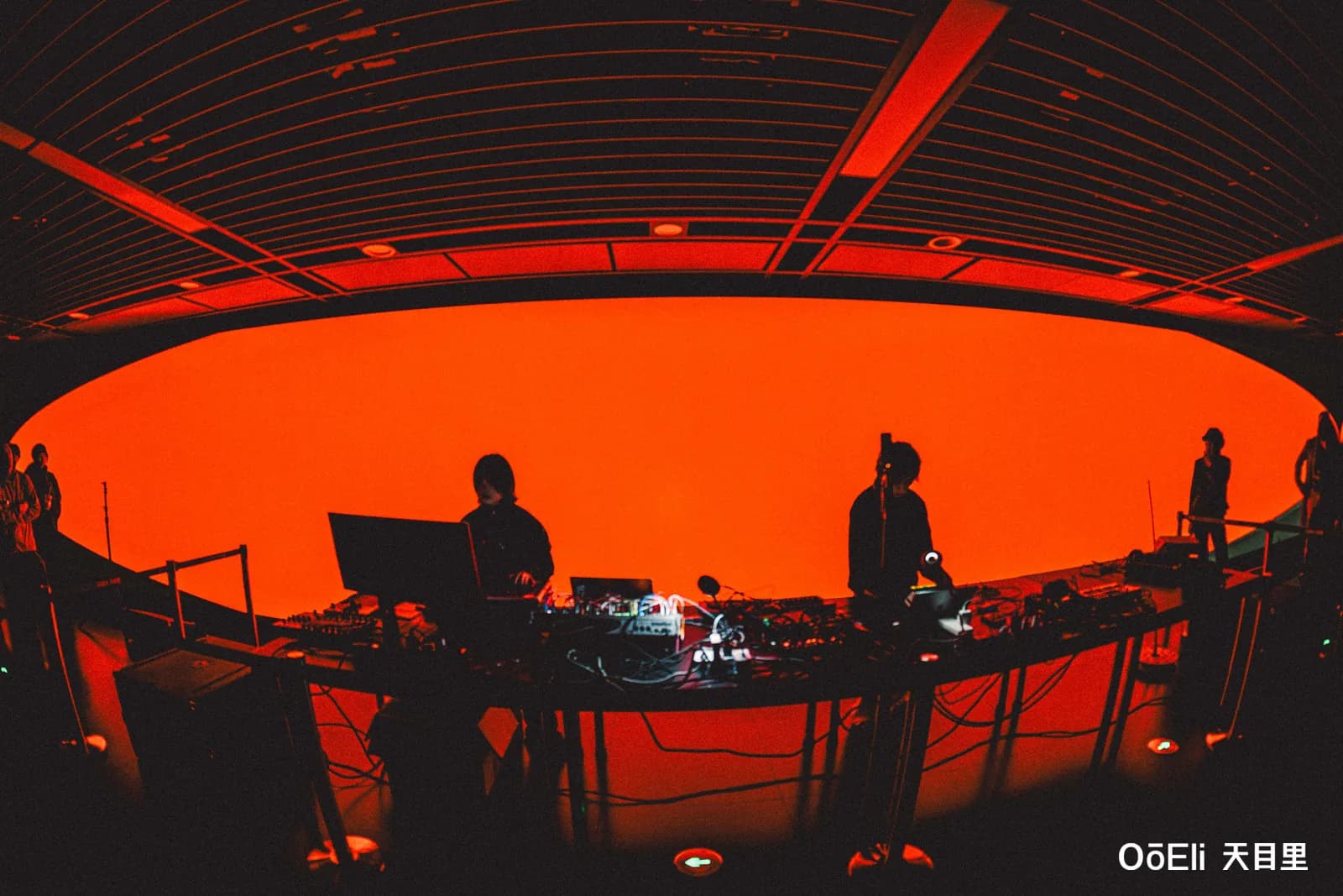 Orange screen illuminating the live performance setup