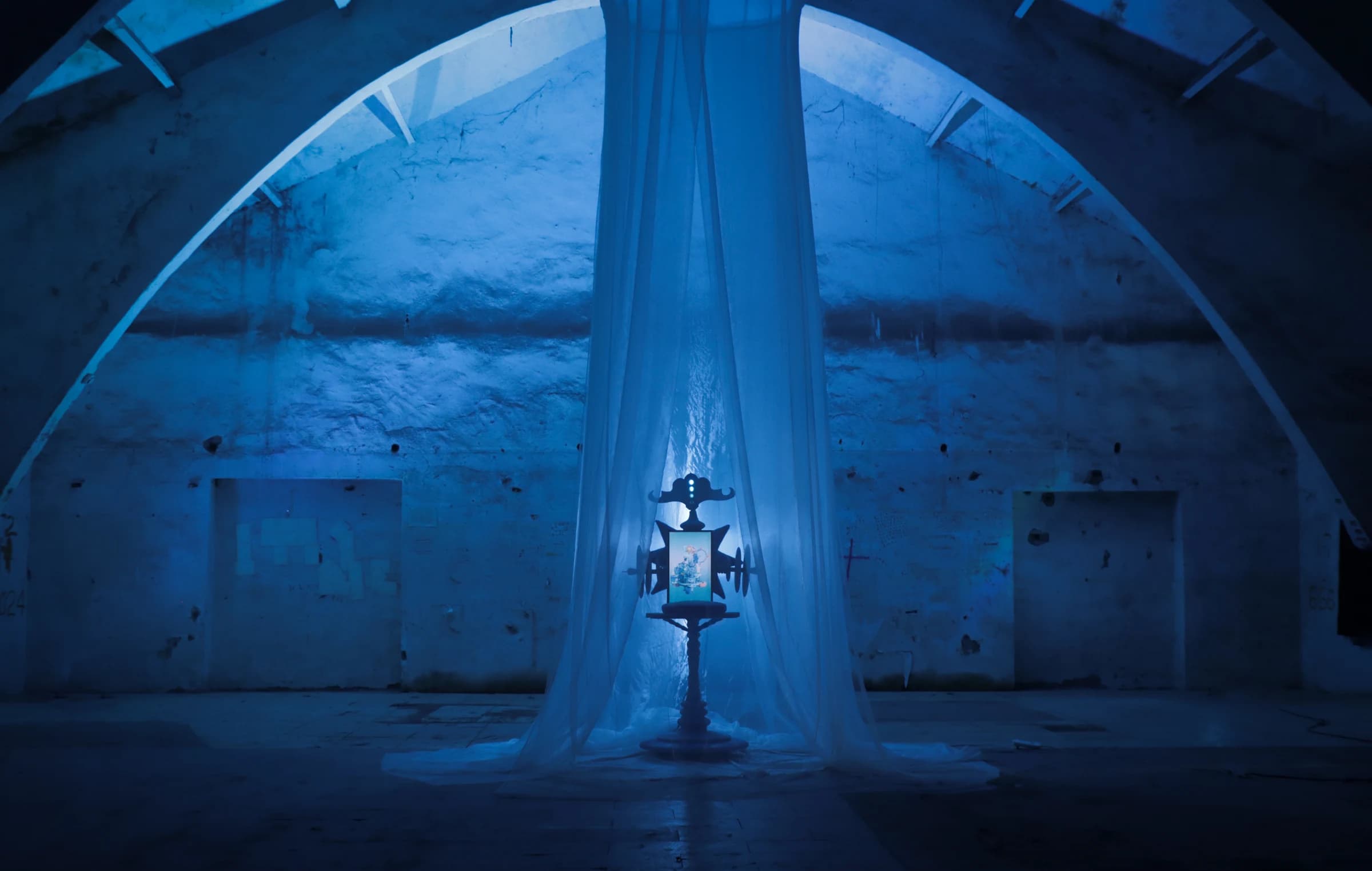 Blue-lit Sleep Town installation beneath a large arch